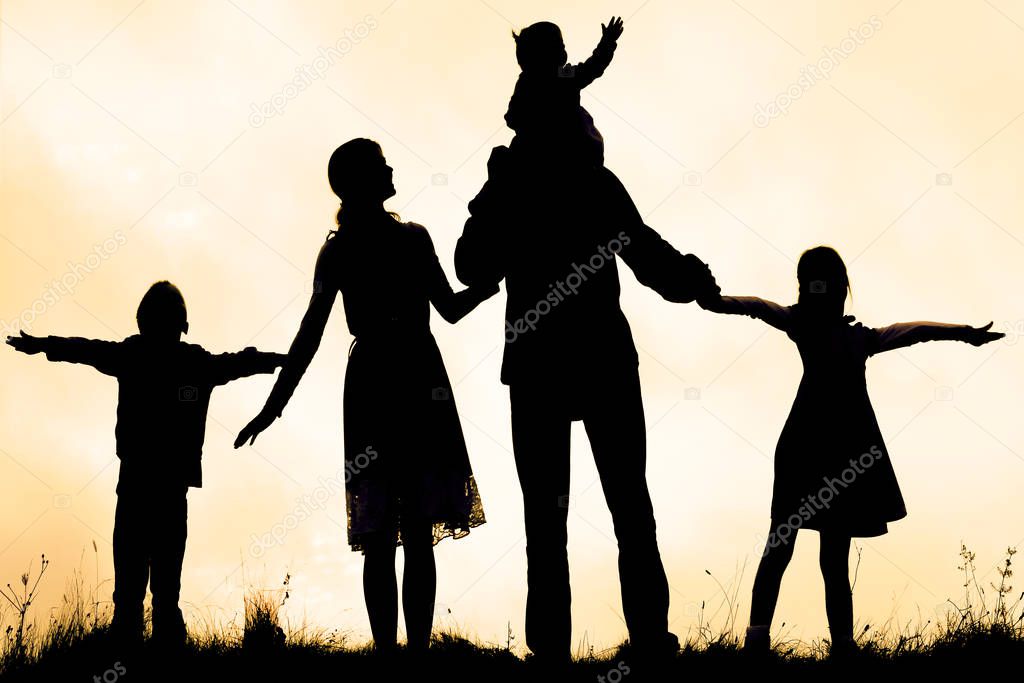 happy family by the sea on nature silhouette background