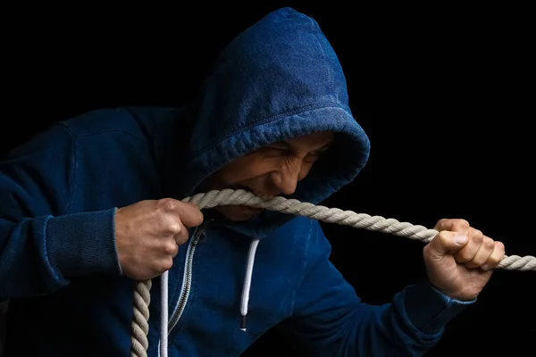 hands with a rope on a black background