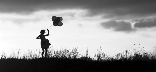 Een Silhouet Kindje Met Ballonnen — Stockfoto
