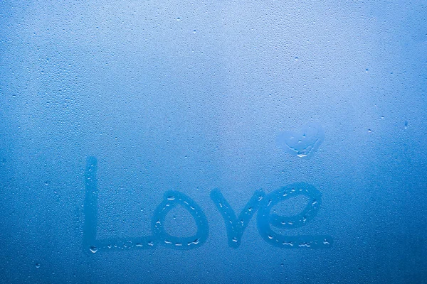 word love written on glass window with drops background