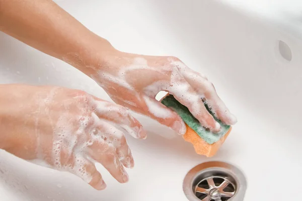 Hands with soap and a washcloth are washed under a tap with water. Clean from infection and dirt and virus. At home or in the hospital bathing
