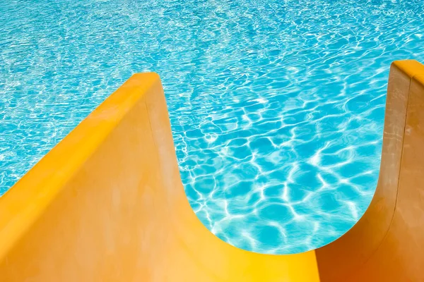 Step with slide in the pool by the sea nature background. For bathing turquoise water.