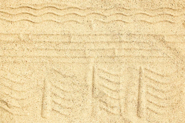 Drawing in the sand near the sea in nature travel background. Hand drawn on vacation.
