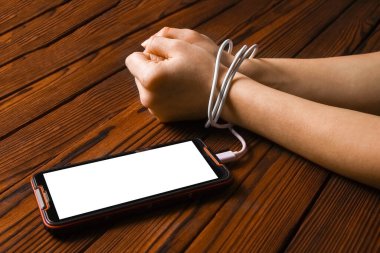 Telefon ahşap bir arka planda el bağımlılığı