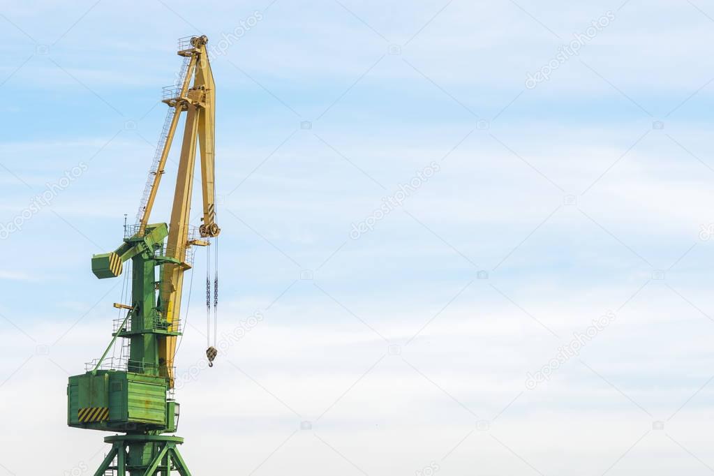 Lifting crane against blue sky background