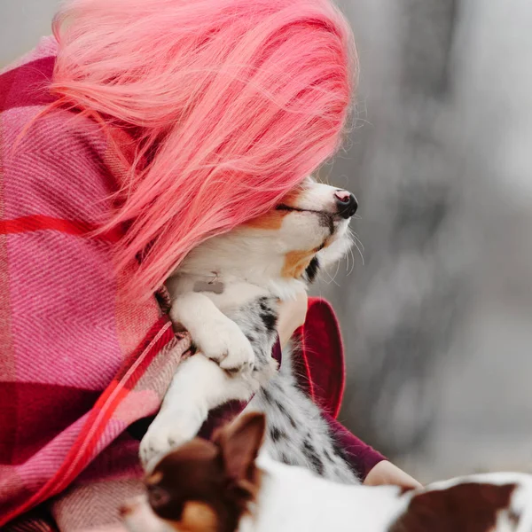 Femme aux cheveux roses étreignant son chiot à l'extérieur — Photo