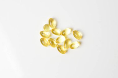 Fish oil pills on a white background. Copy space. clipart