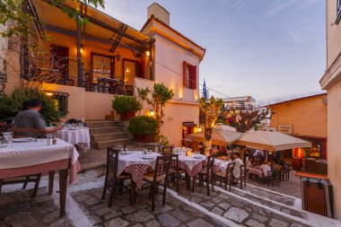 Athens, Yunanistan - 09 Nisan 2018: Bir taverna Plaka, Atina, Yunanistan'ın eski şehir içinde insanlarda. 