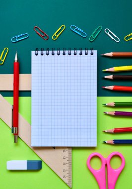 Renkli bir arka planda okul kırtasiyesinin düz kompozisyonu. Yukarıdan görünüşü.