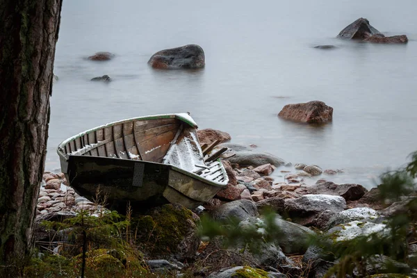 Brooken boat on land at winter