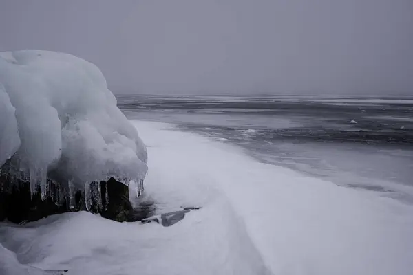 Hielo en una piedra cerca de un lak congelado — Foto de Stock