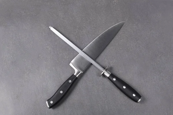 cook knife and sharpener on a slate boar