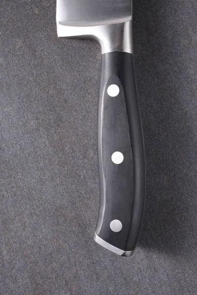 black cook knife handle on a slate board
