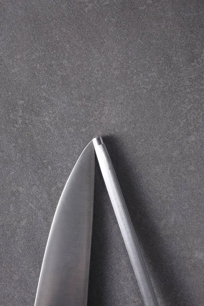 cook knife and sharpener on a slate boar