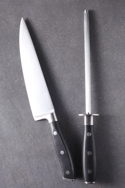 cook knife and sharpener on a slate boar