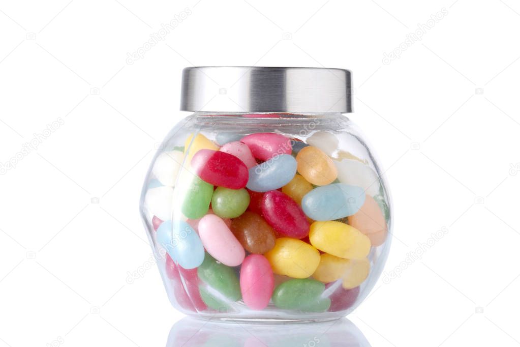 a glass jar full of colored candies with isolated on white background with clipping path 
