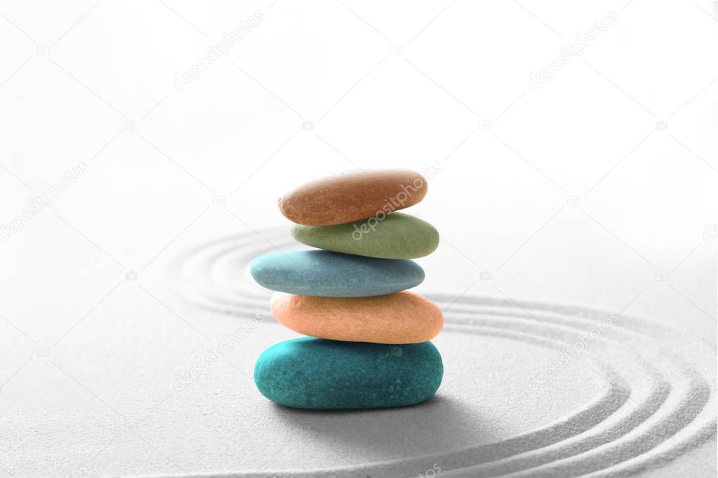zen stone concept, multi colors  stones piled on the sand with copy space for your text