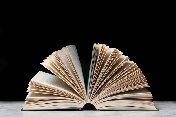 Open book isolated on black background with copy space for your text