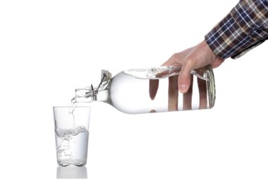 plastic free concept: man's hand fill a water glass with a glass  bottle, clipping path included, isolated on white background and copy space for your text