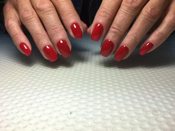 Fashionable red manicure on short square nails — Stock Photo, Image