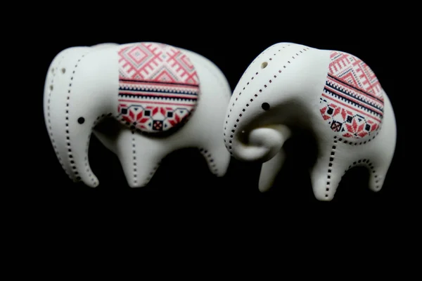 Small ceramic elephant  isolated on black background. — Stock Photo, Image