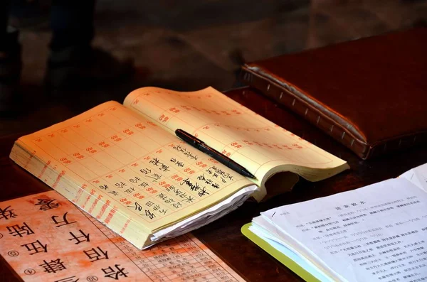 Shanghai, Kina - maj 7 2017: Kinesiska anteckningsbok med penna i templet av staden Gud turistiska enklaven Shanghai, Kina. — Stockfoto