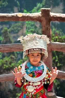 Zhangjiajie, China - May 12, 2017: Little girl in traditional chinese clothes in Wulingyuan Zhangjiajie National Park, China clipart