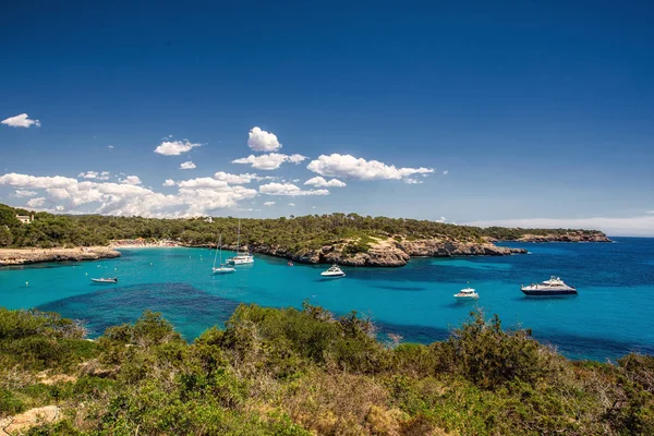 Beautiful view of the bay with turquoise water and yachts in Cala Mondrago National Park on Mallorca island, Spain.