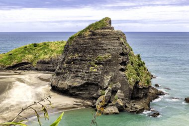 Taitomo Island huge rock view, Auckland west coast, New Zealand clipart