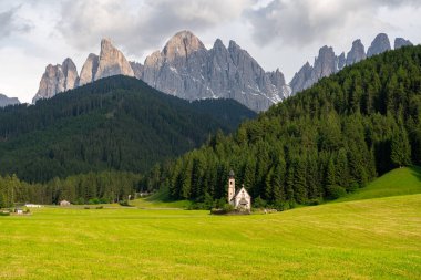 Beautiful lonely church in northern Italy Saint Magdalena at the foot of majestic peaks of Geisler