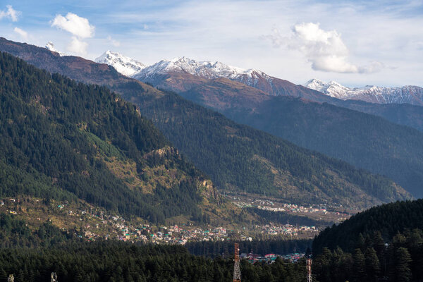 Manali village view in northern India with snow capped Himalayas mountains