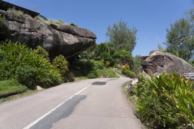 Road in Praslin Island granite rock bolder Seychelles  clipart