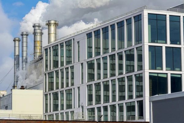 Smoking factory pipes and office building of the factory