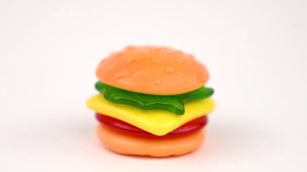 美味迷你软糖汉堡旋转在转身表上的白色背景隔离 糖果版本的经典美国食品 汉堡包 — 图库视频影像