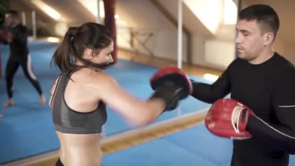 Svettas Kvinna Hård Boxning Träning Med Tränare Gymmet Sidovy — Stockvideo