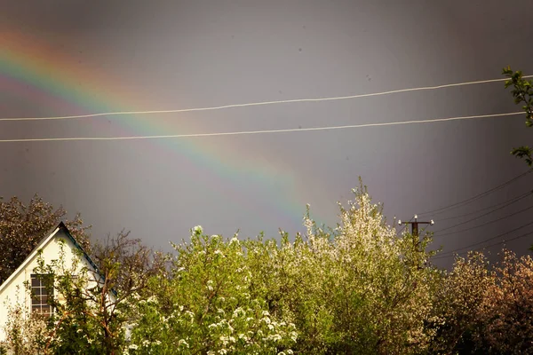 Rainbow against a dark stormy sky.