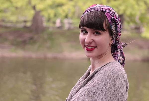 Bir Fularlı Kız gülümseyerek.