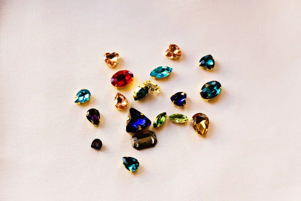 Multicolored artificial stones for jewelry isolated with a white background.