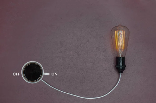 Great concept of caffeine energy, coffee energy. Cup of coffee binding lamp.