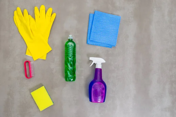 Great concept of cleaning, various products used in cleaning on gray background.