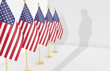 Amerikan bayrakları ve Cumhurbaşkanı Donald Trump silueti.