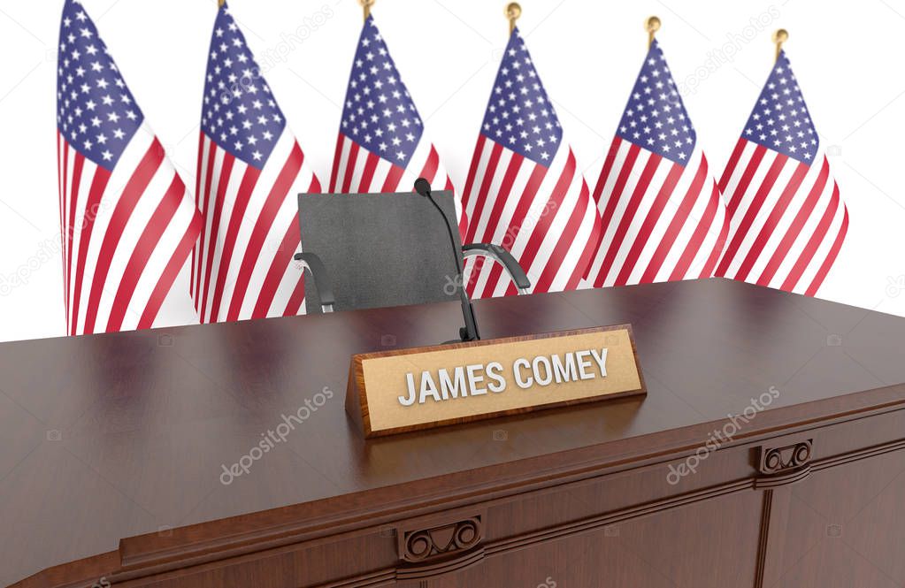 Wooden table with desk plaque JAMES COMEY and american flags in background. 