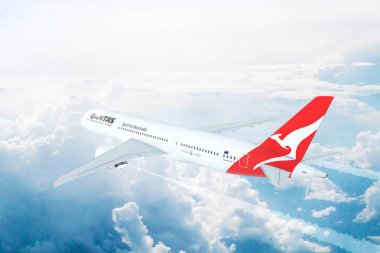 Qantas Boeing 787 Dreamliner yüksekten uçuyor bulutların üzerinde hava uçuş görünümü. 