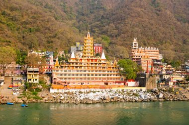 Temples at Laxman Jhula at the Ganga in India clipart