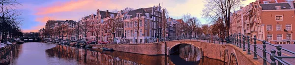 Panorama from the city Amsterdam in the Netherlands at sunset — Stock Photo, Image