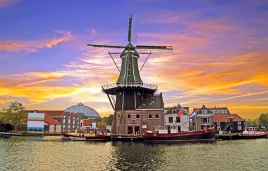 Medieval Adriaan Windmill in Haarlem the Netherlands at sunset clipart