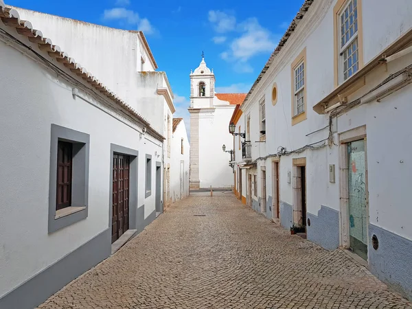 Old medieval street in Lagos with the Maria church in the Algarv — Stock Photo, Image