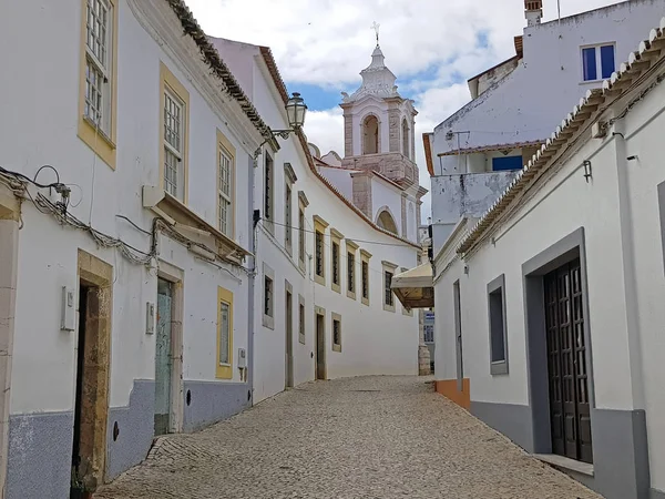 Old medieval street in Lagos with the Maria church in the Algarv — Stock Photo, Image