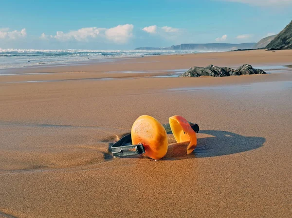 Ear muffs lying on the beach — Stock Photo, Image