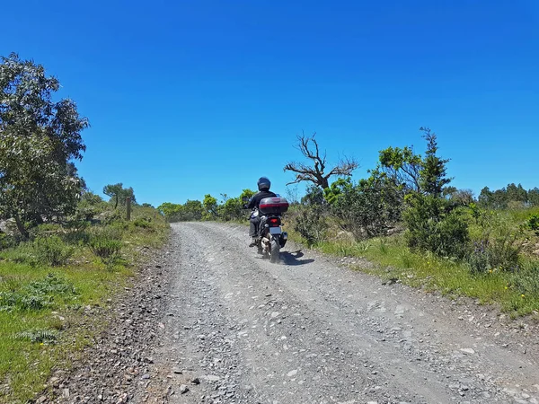 Motor driver driving on a dirt road in the countryside from Port